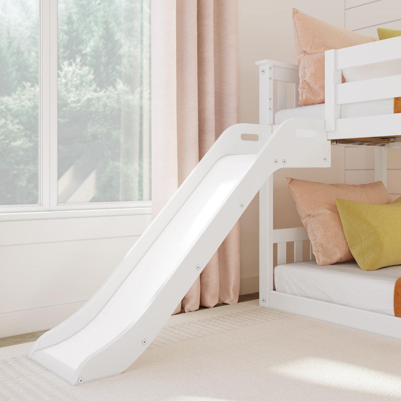White bunk bed with slide in a children's bedroom, featuring pastel pillows and natural light from a large window.