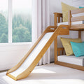 Modern wooden bunk bed with slide in kids' bedroom, yellow and teal cushions, white curtains and large window overlooking misty pine forest