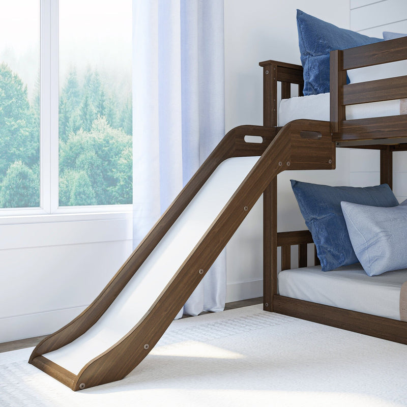 Dark walnut wooden bunk bed with built-in white slide in bright kids' bedroom with blue pillows and large window view