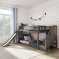Gray wooden bunk bed with slide in modern kids' bedroom, navy and beige bedding, pennant garland on white shiplap wall and light blue curtains