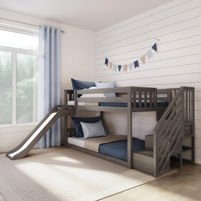 Gray wooden bunk bed with slide and storage stairs in bright kids' bedroom with navy bedding and shiplap wall