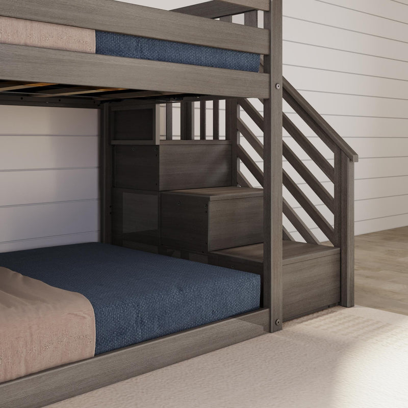 Gray wood twin-over-full bunk bed with built-in storage staircase and navy blue mattress in a modern farmhouse bedroom