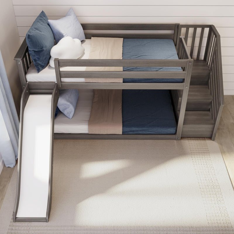 Gray wooden twin-over-twin bunk bed with slide and built-in staircase, modern kids bedroom set with blue and beige bedding and safety rails