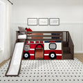 Kids loft bed with slide and stairs featuring a red fire truck playhouse panel, dark wood frame, cozy bedding, white dotted rug and framed truck prints