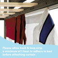 Bed canopy curtain with hook-and-loop adhesive strip secured to wooden bed frame — allow minimum 1 hour for adhesive strip to adhere before attaching curtain