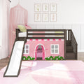 Dark wood children's loft bed with white slide, pink playhouse tent and canopy, stairs and floral wall art in a girl's bedroom