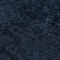 Close-up navy blue textured velvet fabric with soft pile and subtle linear striations, luxury upholstery or rug background
