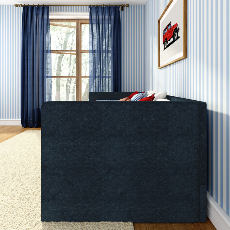 Modern cozy bedroom interior with navy sofa, blue-and-white striped wallpaper, sheer navy curtains, wooden window, decorative pillows and framed red car wall art