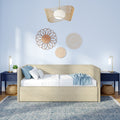 Boho coastal bedroom interior with beige upholstered daybed, navy blue nightstands, rattan pendant light, woven wall decor, blue throw pillows and geometric area rug