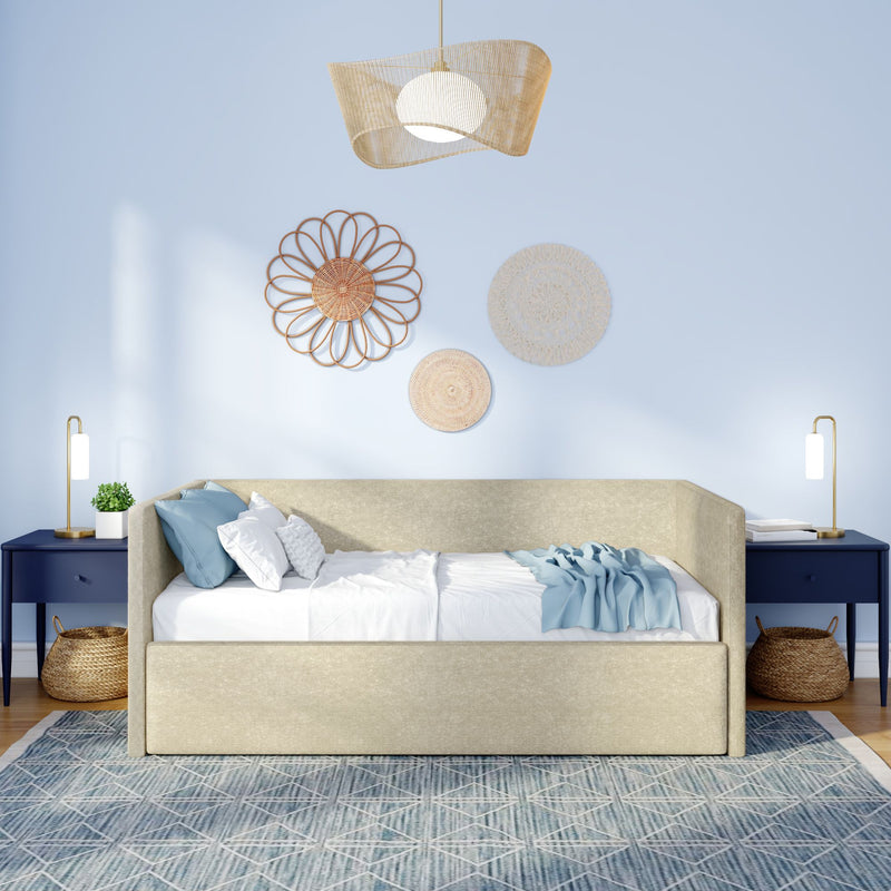 Boho coastal bedroom interior with beige upholstered daybed, navy blue nightstands, rattan pendant light, woven wall decor, blue throw pillows and geometric area rug