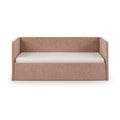 Blush pink upholstered daybed with tall back and side rails and white mattress — modern kids' sofa bed for nursery or guest room