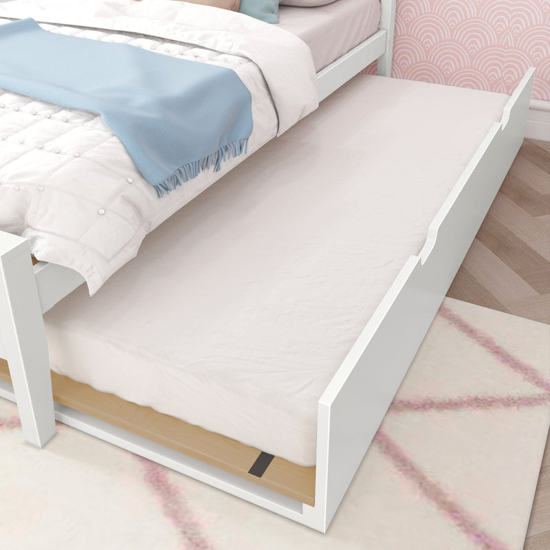 White trundle bed with pull-out mattress under a white twin bed in a pastel kids’ bedroom with blue throw blanket and pink patterned wallpaper