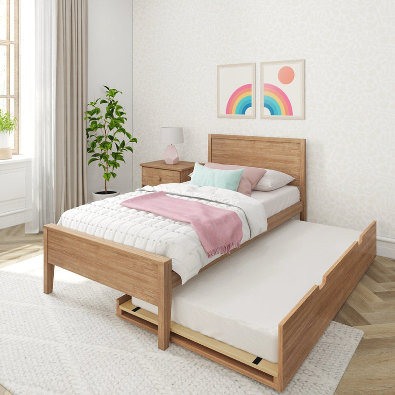 Stylish bedroom with wooden bed frame and trundle, pink and white bedding, modern decor, and natural light.