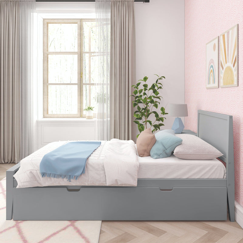 Stylish modern bedroom with grey bed frame, blue blanket, pastel pillows, and a large window providing natural light.