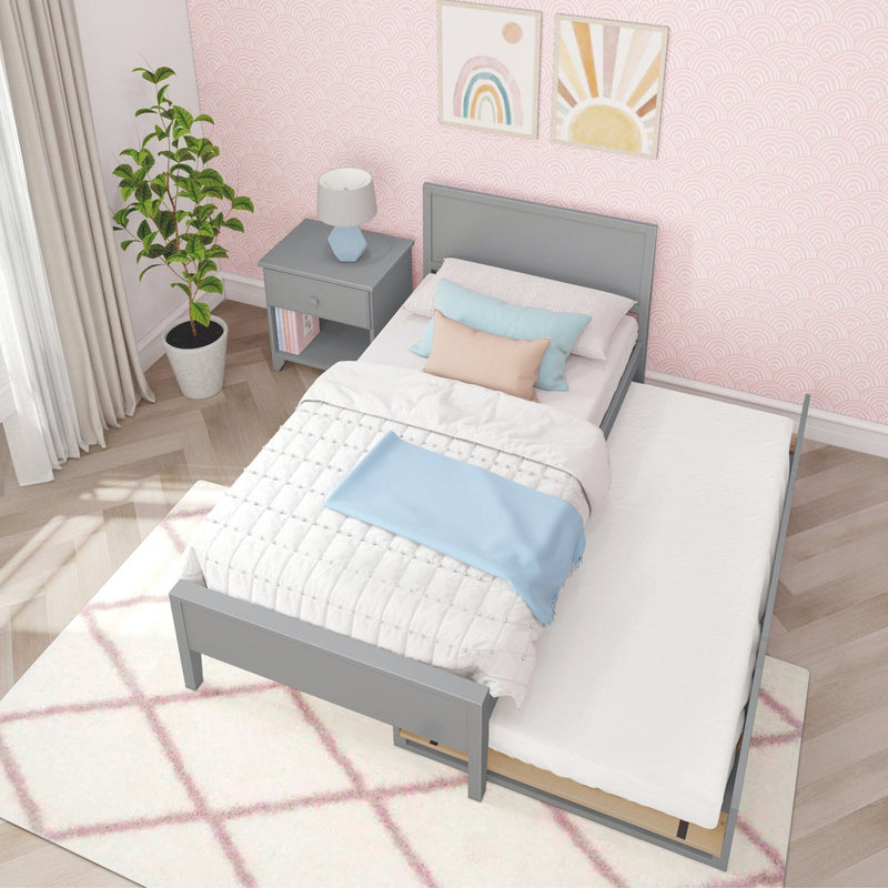 Gray twin bed with pull-out trundle in a pink-themed bedroom with Scandinavian decor and natural light.