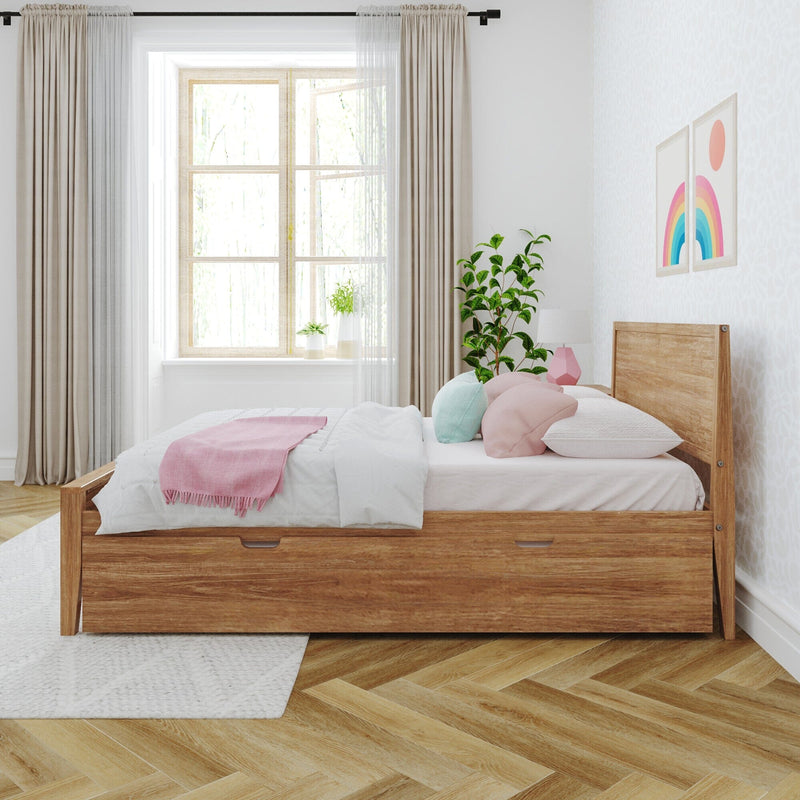 Cozy bedroom with wooden bed frame, pastel pillows, soft blankets, and natural light from a large window.