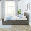 Modern minimalist bedroom interior featuring a dark wood storage bed with white bedding and pastel pillows, light blue throw, large window with sheer curtains and natural light, potted indoor plant and framed wall art for Scandinavian-style decor