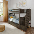 Gray wooden twin-over-twin bunk bed with storage stairs, striped bedding, sun plush and rainbow wall art in kids' bedroom
