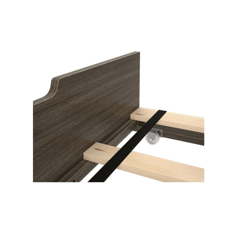 Dark wood headboard close-up with wooden slats, metal center support rail and caster wheel — bed frame assembly detail for rustic bedroom furniture