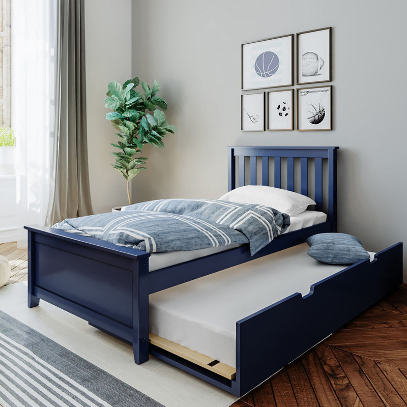 Navy blue wooden twin bed with pull-out trundle, blue striped duvet and pillow in a modern kids bedroom with hardwood floor, potted plant, framed sports wall art and natural light