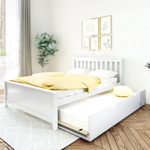 Bright minimalist bedroom featuring a white wooden trundle bed with pull-out mattress, yellow polka-dot duvet and pillow, botanical framed prints, potted green plant, and light herringbone wood floor
