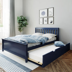 Modern navy blue wooden bed with pull-out trundle drawer, blue striped bedding, hardwood floors, rug, houseplant and framed wall art in a bright minimalist bedroom