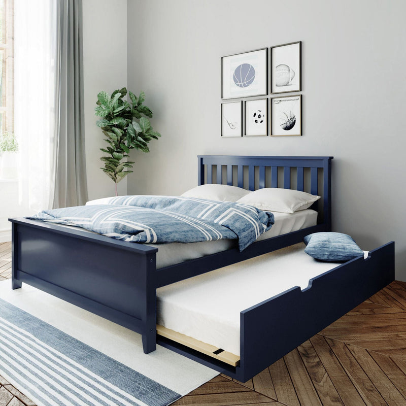 Modern navy blue wooden bed with pull-out trundle drawer, blue striped bedding, hardwood floors, rug, houseplant and framed wall art in a bright minimalist bedroom