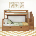 Wooden bunk bed with stairs and under-bed drawer, green bedding and pillows, cactus print wall art above, cozy kids' bedroom setup