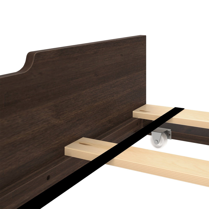 Wooden bed frame assembly with caster wheel for easy mobility.