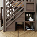 Modern rustic wooden loft bunk bed with diagonal slat railing and built-in storage cubbies holding magazines, white geometric decor and navy sneakers on hardwood floor