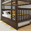 Dark brown wooden bunk bed with ladder and pull-out trundle drawer, styled with gray bedding and yellow accent pillows in a modern kids' bedroom