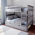 Gray wooden bunk bed with ladder and pull-out trundle drawer, blue-gray bedding in a modern kids' bedroom by a window