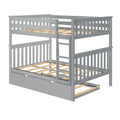 Gray wooden twin-over-twin bunk bed with ladder, slatted mattress platforms and pull-out trundle drawer for kids' bedroom
