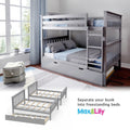 Gray wooden convertible bunk bed with ladder, trundle drawer and blue bedding in a bright kids' bedroom, converts into two twin beds