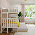 White wooden two-level bunk bed with pull-out trundle in pink modern children's bedroom with yellow accents, large window bench and indoor plant