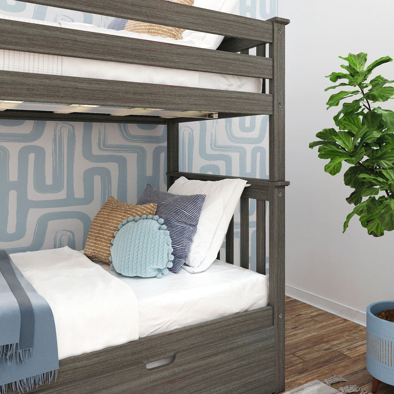 Gray wood twin-over-twin bunk bed in kids bedroom with white bedding, blue striped and tan throw pillows, knitted round blue cushion, geometric blue wallpaper, fiddle leaf fig plant and hardwood floor