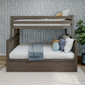 Gray wooden twin-over-full bunk bed with under-bed storage drawer, white bedding and blue throw pillows in a children's room with geometric wallpaper and potted plant