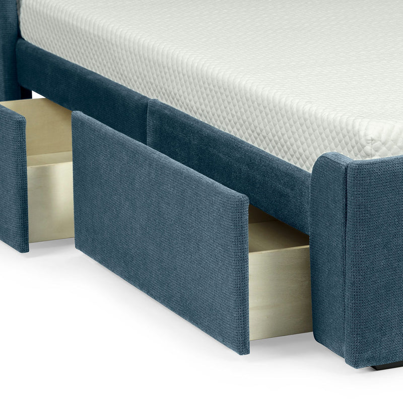 Blue upholstered platform bed with built-in pull-out storage drawers and white quilted mattress