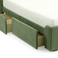 Green upholstered bed with open under-bed storage drawers and a white quilted mattress.