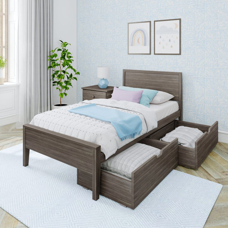 Gray wood twin platform bed with two underbed storage drawers in a bright modern bedroom with blue throw blanket, pastel pillows, nightstand and framed wall art