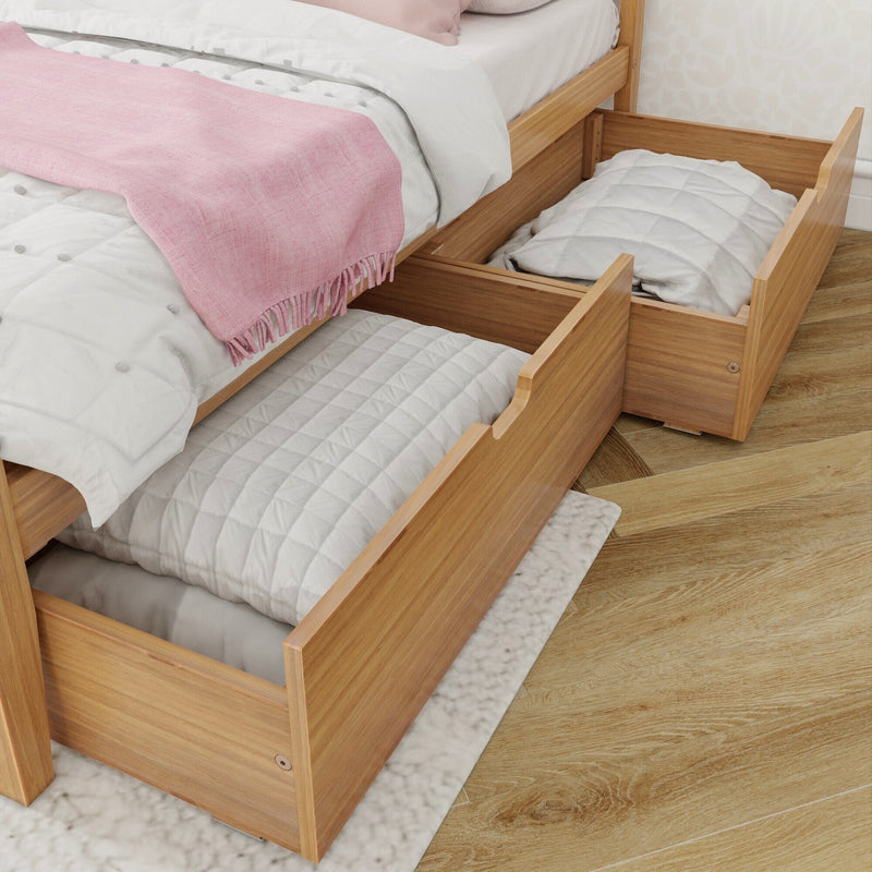 Wooden bed frame with open under-bed storage drawers filled with folded quilts on a wooden floor.