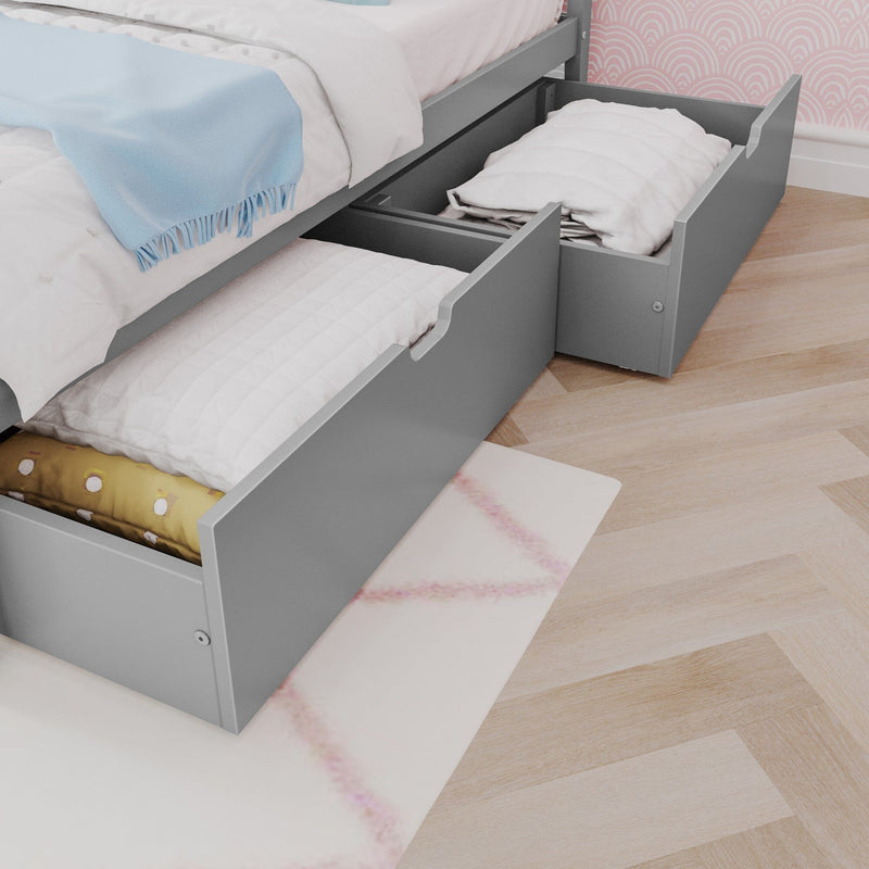 Under-bed storage drawers filled with bedding and blankets in a modern bedroom setting.