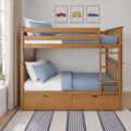 Natural wood twin-over-twin bunk bed with blue bedding, ladder and built-in storage drawers in a bright children's bedroom with vintage car wall art