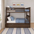 Wooden twin-over-twin bunk bed with blue bedding, ladder and under-bed storage drawers in a modern kids' bedroom with framed vintage car prints, neutral curtains and striped blue rug