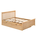 Wood platform bed with storage drawers and vertical slatted headboard in a light natural wood finish, exposed mattress slats and sturdy wood frame