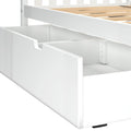 White wooden under-bed storage drawer with cutout handle and internal divider, fits slatted platform bed for space-saving bedroom organization