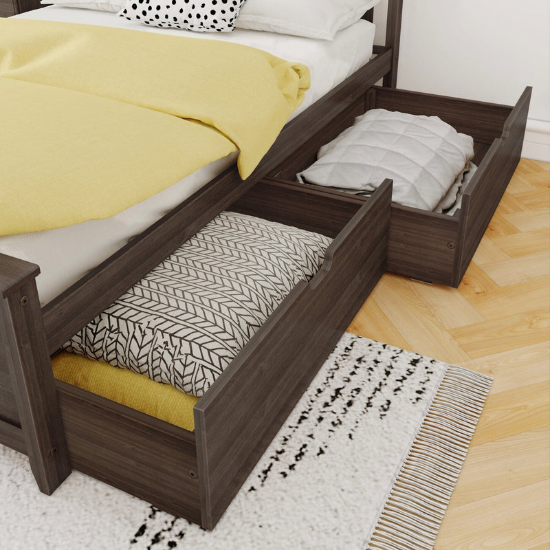 Dark wood platform bed with pull-out underbed storage drawers storing folded bedding, yellow duvet and patterned pillows in a modern bedroom