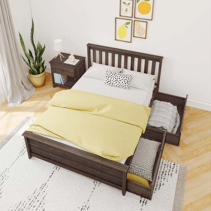 Scandinavian bedroom with dark wood platform bed and under-bed trundle storage, yellow duvet, polka-dot pillow, bedside table, lamp and potted plant