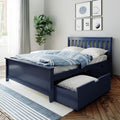 Navy blue wooden bed with underbed storage trundle and blue striped duvet in a bright modern coastal bedroom with fiddle-leaf plant and sports-themed wall art