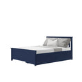 Navy blue wooden storage bed with under-bed drawers, white mattress and gray textured pillows and throw on white background